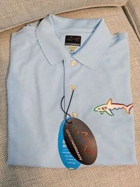 Greg Norman Collection Men's Light Blue Performance Polo with Shark Logo